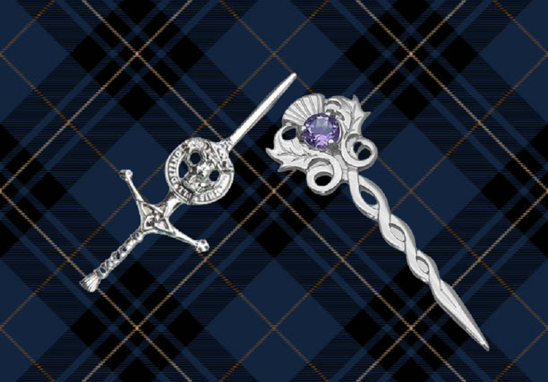 Close-up shot showcasing a beautifully crafted kilt pin securely fastened on a vibrant tartan kilt. The intricate details of the pin add elegance and style to the traditional Scottish attire.