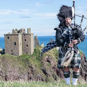 man in Traditional irish kilt sea view. charming