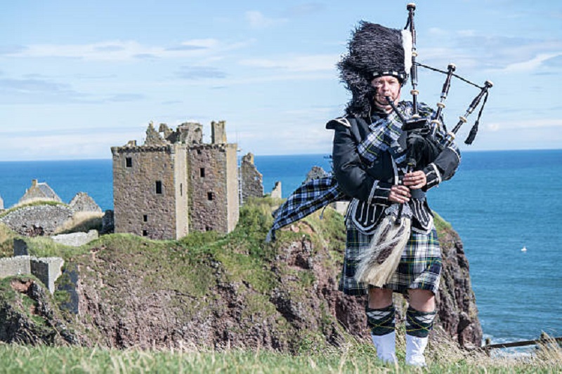 man in Traditional irish kilt sea view. charming