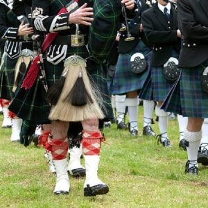 men marching wearing different kilt.