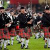 Men wearing vibrant red Scottish kilts, marching proudly in traditional Highland Games held each year in Dunoon in Scotland.The blurred background adds a dynamic touch, capturing the energy and camaraderie of the moment. Experience the cultural richness and tradition as this group showcases the timeless allure of Scottish kilts.