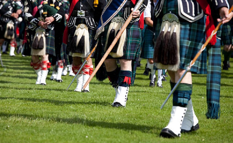 Scottish men wearing traditional kilts.