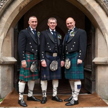 image of three men wearing traditional kilt outfit.