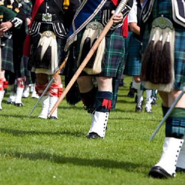 Scottish men wearing traditional kilts.